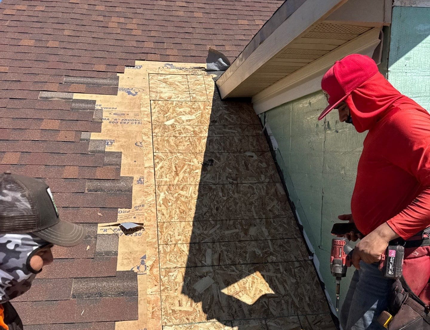 Spearfish Emergency Roofing Services by Wegner Roofing & Solar crew using a coil nailer and blower to replace torn shingles.