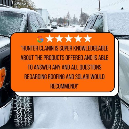 A snowy street scene with a five-star review sign about roofing and solar knowledge between two snow-covered cars.